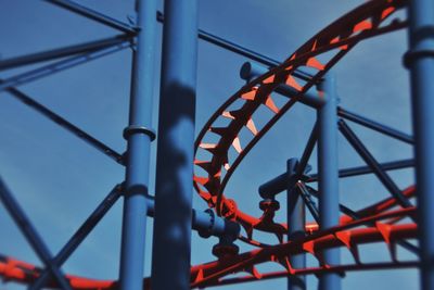 Low angle view of chain swing ride against sky