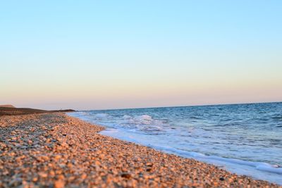 Scenic view of beach against clear sky