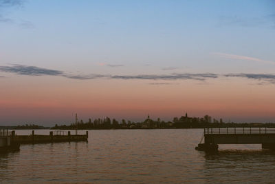 Silhouette of boat in sea during sunset