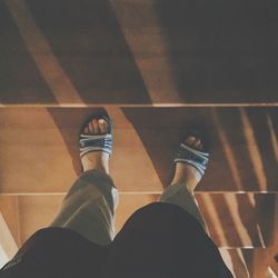 Low section of woman standing on tiled floor