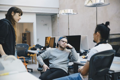 Computer programmers discussing strategy in creative office