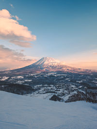 Scenic view of snowcapped mt. yotei against sky during sunset taken from niseko