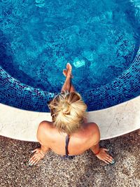 High angle view of woman relaxing in swimming pool