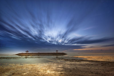 Scenic view of beach against sky during sunset