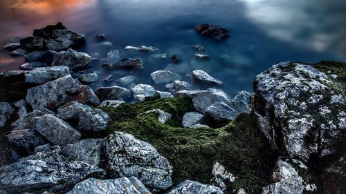 Rocks in sea against sky