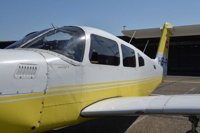 Airplane on runway against clear sky