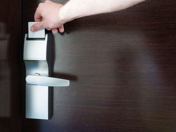 Cropped image of man opening door with key card at hotel