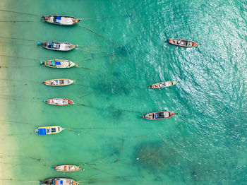 Aerial view top down longtail fishing boats at the sea in phuket thailand