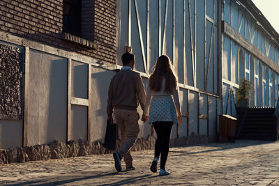 Rear view of people walking on street