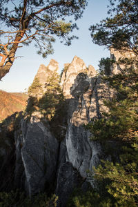 Low angle view of rocks against sky