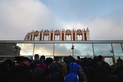 People at event against cloudy sky