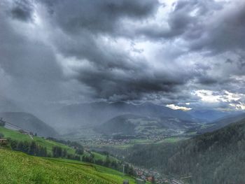 Scenic view of landscape against cloudy sky