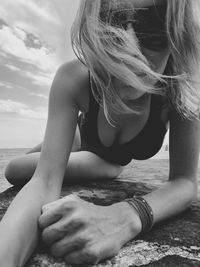 Close-up of thoughtful woman with hand on beach