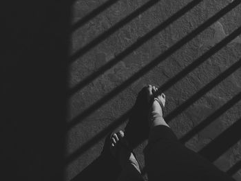Low section of person on tiled floor