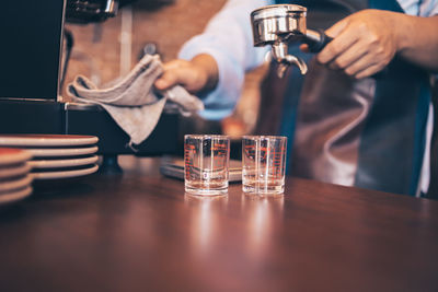 Midsection of people in glass on table