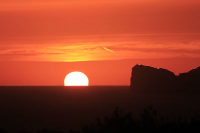 Scenic view of silhouette landscape against romantic sky at sunset