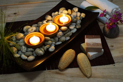 High angle view of illuminated candles on table