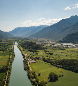 Scenic view of landscape and mountains against sky and river