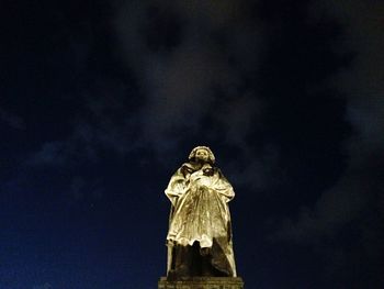 Low angle view of statue against cloudy sky