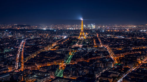 High angle view of city lit up at night