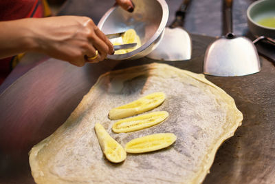 Midsection of person preparing food on table