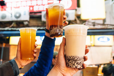 Close-up of hand holding coffee cup