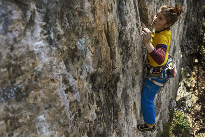 Woman climbing on rock