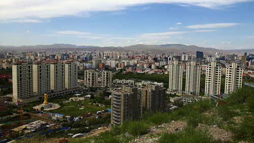 High angle view of buildings in city against sky