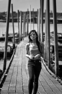 Rear view of woman standing on pier