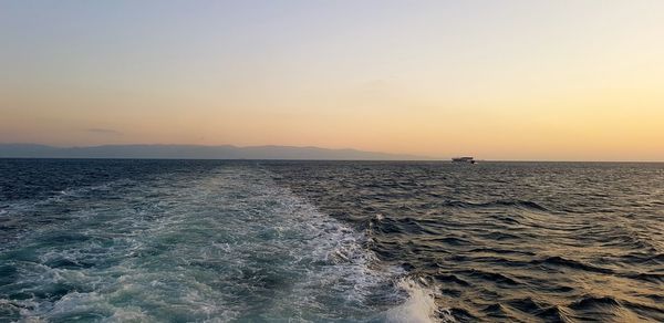 Scenic view of sea against clear sky during sunset