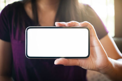 Midsection of woman using mobile phone