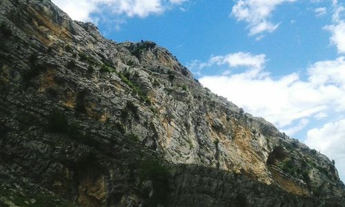 Low angle view of rock formation against sky