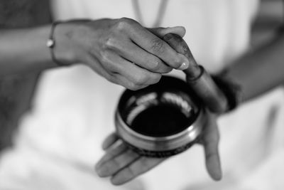 Close-up of woman holding singing bowl