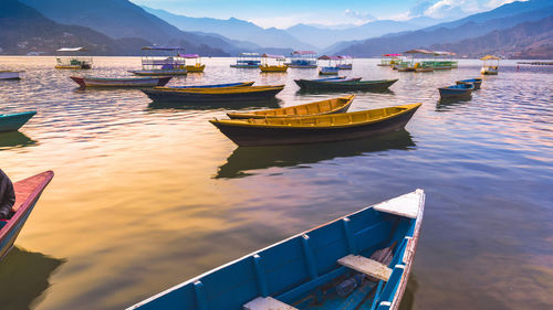 High angle view of boats moored in lake against sky