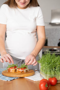 Midsection of woman preparing food at home