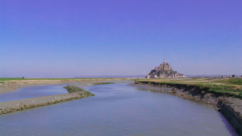 Scenic view of building against clear blue sky