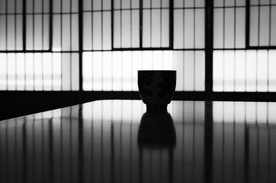 Silhouette and reflection of a japanese tea cup in a japanese house.