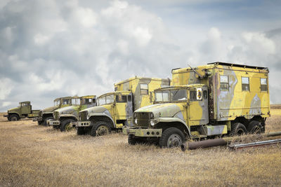 Abandoned truck on field against sky