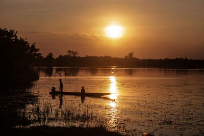 Scenic view of lake against sky during sunset