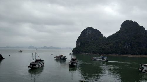 Fishing boats moored on sea