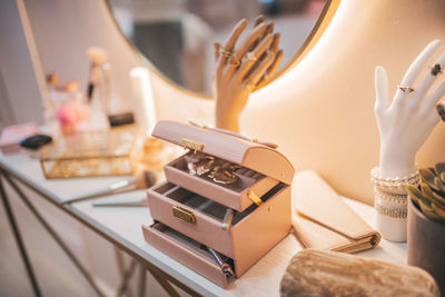 Cropped hand of woman using laptop on table