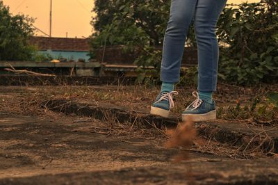 Low section of person standing on field