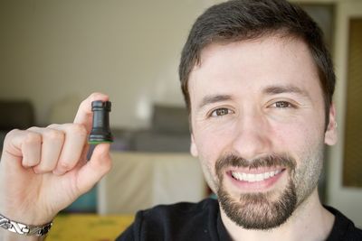 Portrait of young man holding electronic cigarette