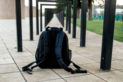 Black backpack under metal structure