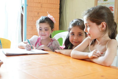 Portrait of friends on table