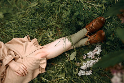 Low section of woman sitting on plants