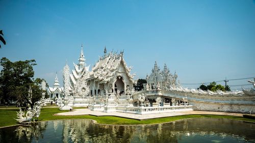 Statue of temple against clear blue sky