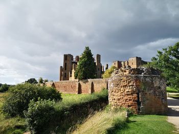 Old ruin on field against sky