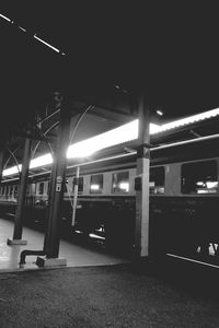 Illuminated railroad station platform at night