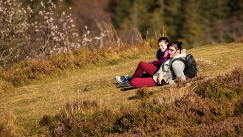 Woman sitting on grass in field